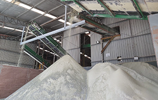 Stockpiling crushed glass for use in roads. 