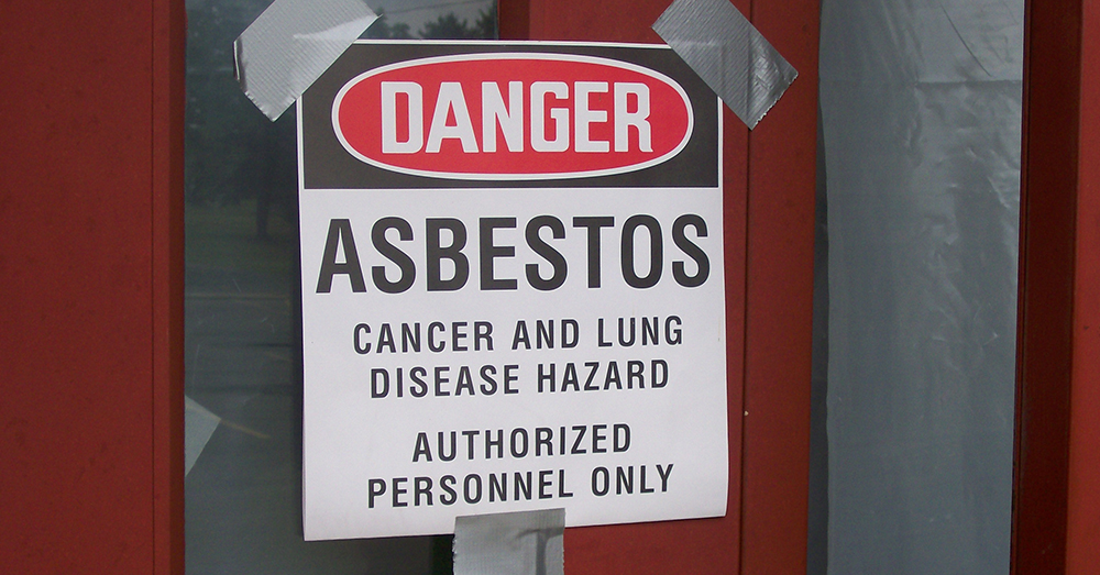 A sign warning of the risks of asbestos exposure. 