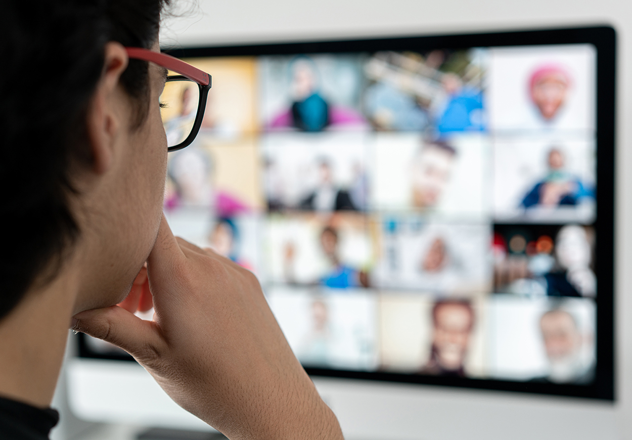 Woman looking at Teams/Zoom meeting screen.