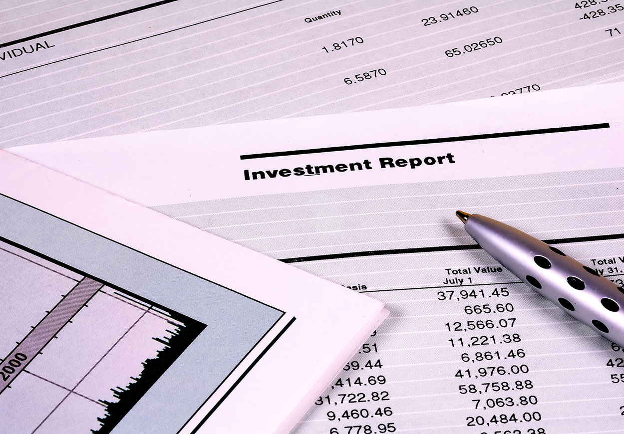 A pen resting on a document labelled Investment Report.