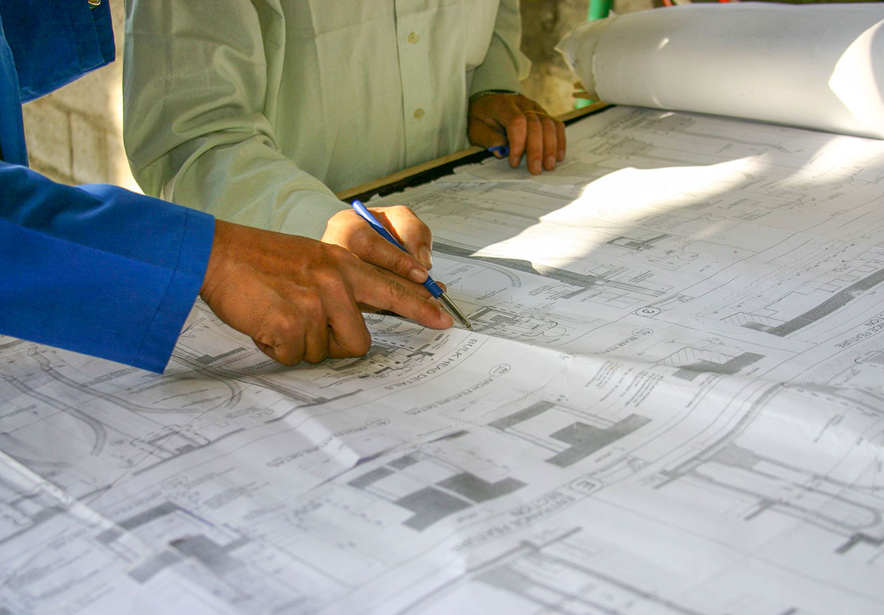 Two people looking at building plans.
