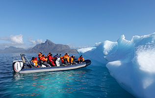 People on rubber duckie near iceberg