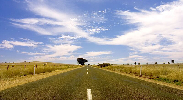 Looking  at a piece of highway stretching into the distance.