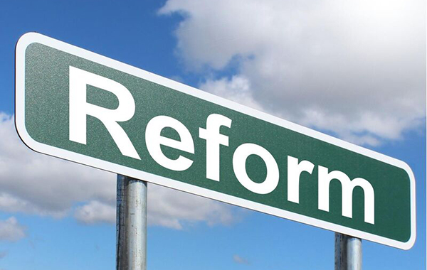 Stylised roadside sign that reads reform.